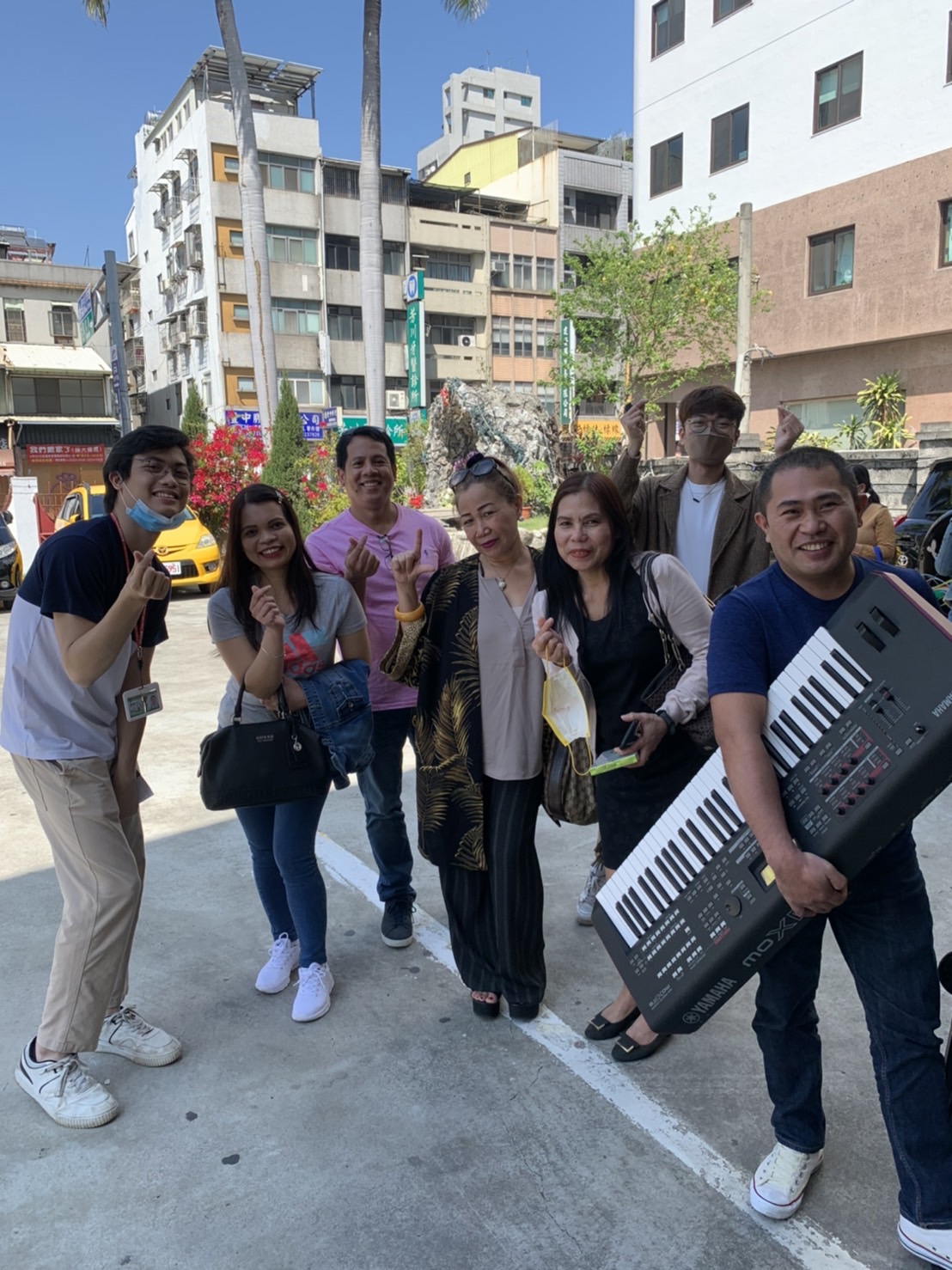 Taiwan FactCheck Center's staff, volunteers, and overseas Filipinos posed in front of the church. (Photo by Gino Lopez)