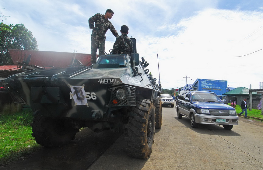 An Army tank sits at a checkpoint in Marantao town in Lanao del Sur on July 9, 2012, the first day of the 10-day re-listing of voters in the Autonomous Region in Muslim Mindanao. MindaNews photo by FROILAN GALLARDO. 