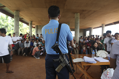 A policeman stands guard at the registration in Timanan, South Upi, Maguindanao.