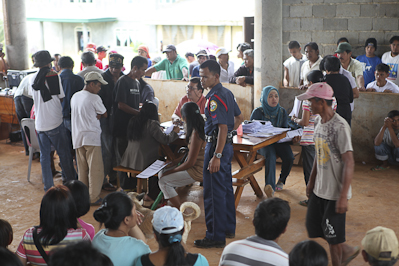 A policeman stands guard inside the registration center in Timanan, South Upi, Maguindanao. Photo by AMIEL MARK CAGAYAN.