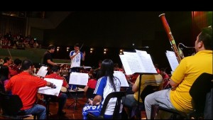 A student from a visiting school tries conducting the ABS-CBN Philharmonic orchestra.