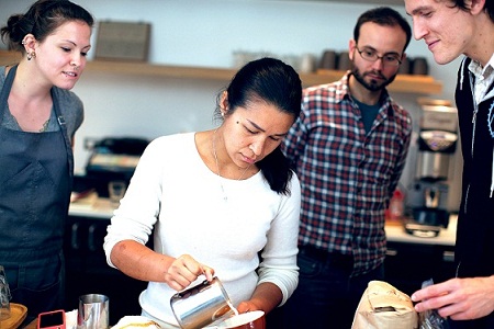 Barista Selina Viguera demonstrates the fine points of making coffee.