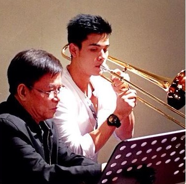 Xian Lim gets extra tutoring from trombone player Romy San Jose.