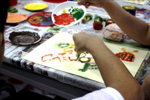 Carl adds the finishing strokes to his art work, which is now displayed in the exhibit (Photo by EIMOR SANTOS)