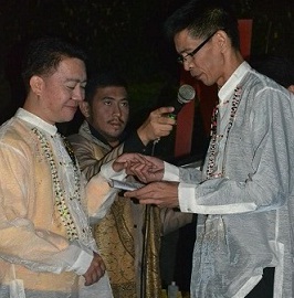 Myke Sotero (right) exchanges vows with his partner Gregory Rugay (left) in a same sex union ceremony last December.