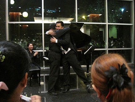 Tenor Espiritu  and pianist Najib Ismail hug after the last encore
