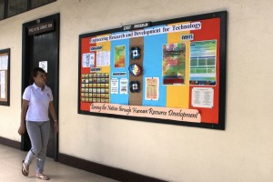 A student walks past the ERDT billboard inside the UP College of Engineering