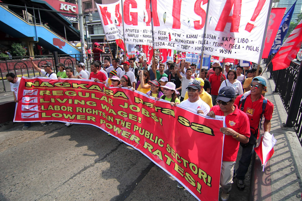 Labor groups march To Mendiola demanding higher wages and better benefits for workers during the May 1 rally.  Photo by Vincent Go