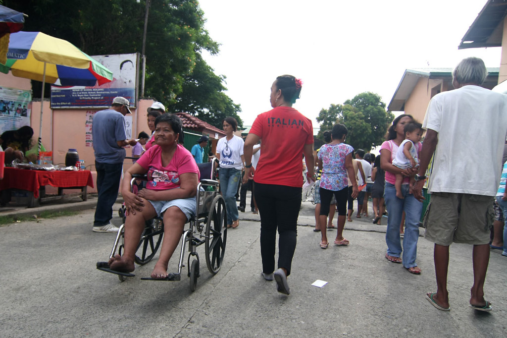 A voter with disability goes home after  finding out that ballots have not yet arrived for the special cluster precincts for PWDs early in the morning at the Sta. Cruz Elementary School in Area E, Dasmarinas, Cavite on May 14. Photo by VINCENT GO