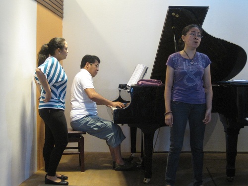 Vibal (right) rehearses while Meneses does page-turning chore for Ismail