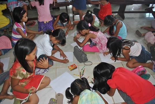 Children from the World Vision-Child Friendly Space of Brgy.Botongon, Estancia, Iloilo show their drawings.