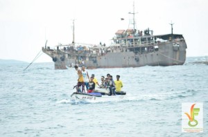 In what looks like a scene from the movie Waterworld, fishers return to their homes in Negros Oriental after months at sea on board this paaling fishing boat taken from the shores of the town of Amlan, under the watchful eyes of of the PIACAT looking out for minors and undocumented workers.