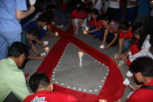 Sta Ana Manila Hospital staff and HIV prevention advocates light candles in memory of those who died of AIDS.