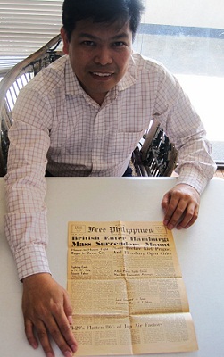 Solares unfolds a yellowing copy of Free Philippines where the first post-war MSO concert was announced.