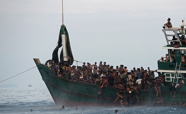 NY Times: Rohingya migrants swam to collect food supplies dropped by a Thai Army helicopter in the Andaman Sea. Credit Christophe Archambault/Agence France-Presse — Getty Images