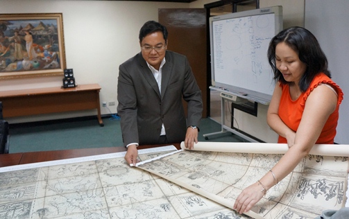 Businessman Mel Velarde looks at the reproduction of the 1734 Murillo map he now owns
