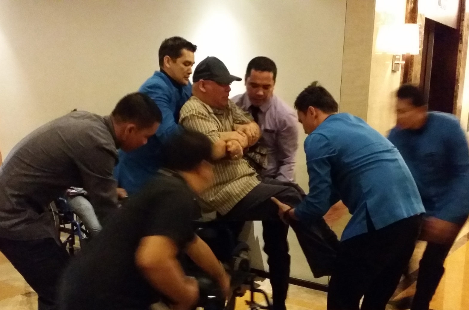 Two hotel employees are assigned to bring CPAP's Denny Ilagan to "safety"