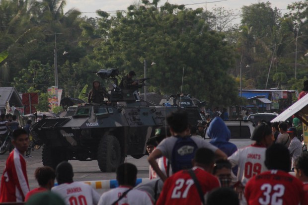 An armored Personnel Carriers (APC) moves closer to the gates of Tambunan Central Elementary School in Guindulungan town, Maguindanao after a supporter of a mayoralty candidate was shot dead about half an hour after polls opened at 6 a.m. on Monday. MindaNews photo by TOTO LOZANO
