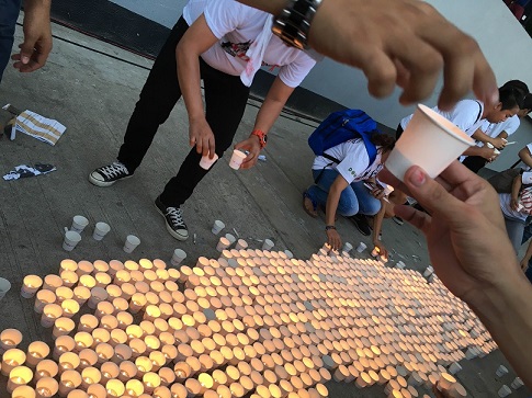 Lighted candles being prepared for the AIDS Hour.