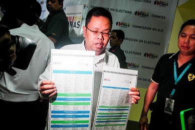 Comelec Spokesman James Jimenez holds a sample ballot. Photo be Feona Imperial