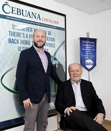 Philippe Lhuillier (seated) with his son, Philippe Andre, at the oponing of Cebuana Lhuillier in Dubai. Photo from kaCebuana website.