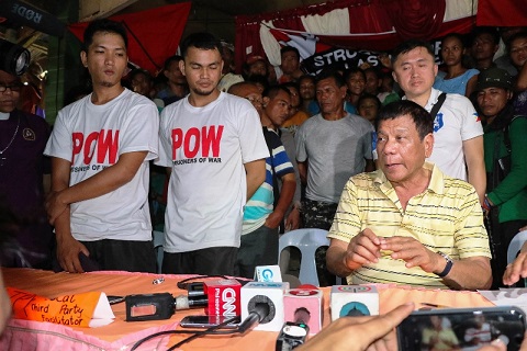 Captured policemen released by NPA to Davao City Mayor Rodrigo Duterte before the May 9 election.
