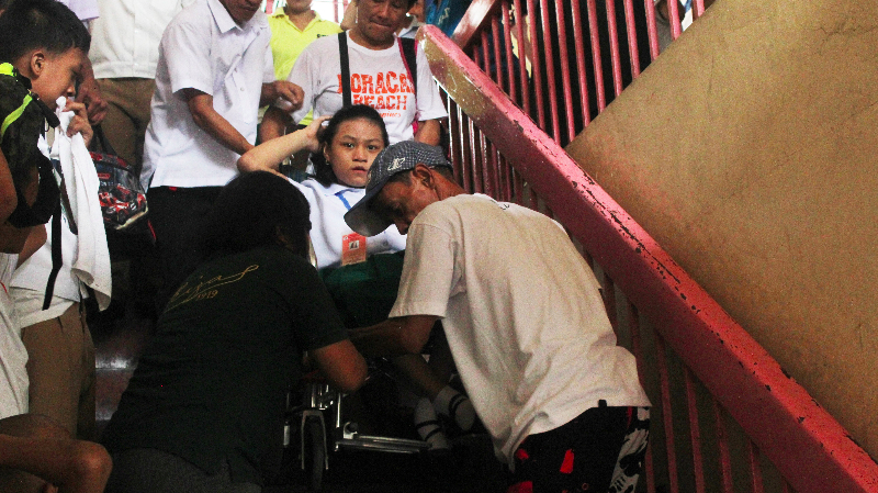 Four teachers help carry a student in a wheelchair from the JPRES SPED center's second floor. Photo by ALLAN YVES BRIONES