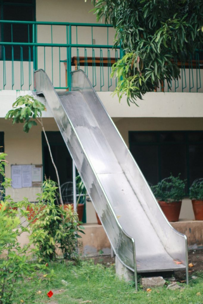 A silver slide that functions as a fire exit stands out in the PNSB's playground. Photo by NICOLE AGATHA CRUZ
