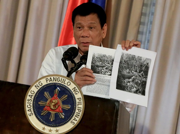 President Rodrigo Duterte shows images of the Bud Dajo massacre during his speech at the 2016 Metrobank Foundation's Outstanding Filipinos awarding ceremony in Malacañang.Photo by Rey Baniquet/PPD