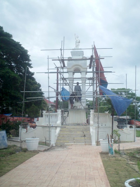 Statue of Rizal with Statue of Liberty on top being rebuilt in Loon town.