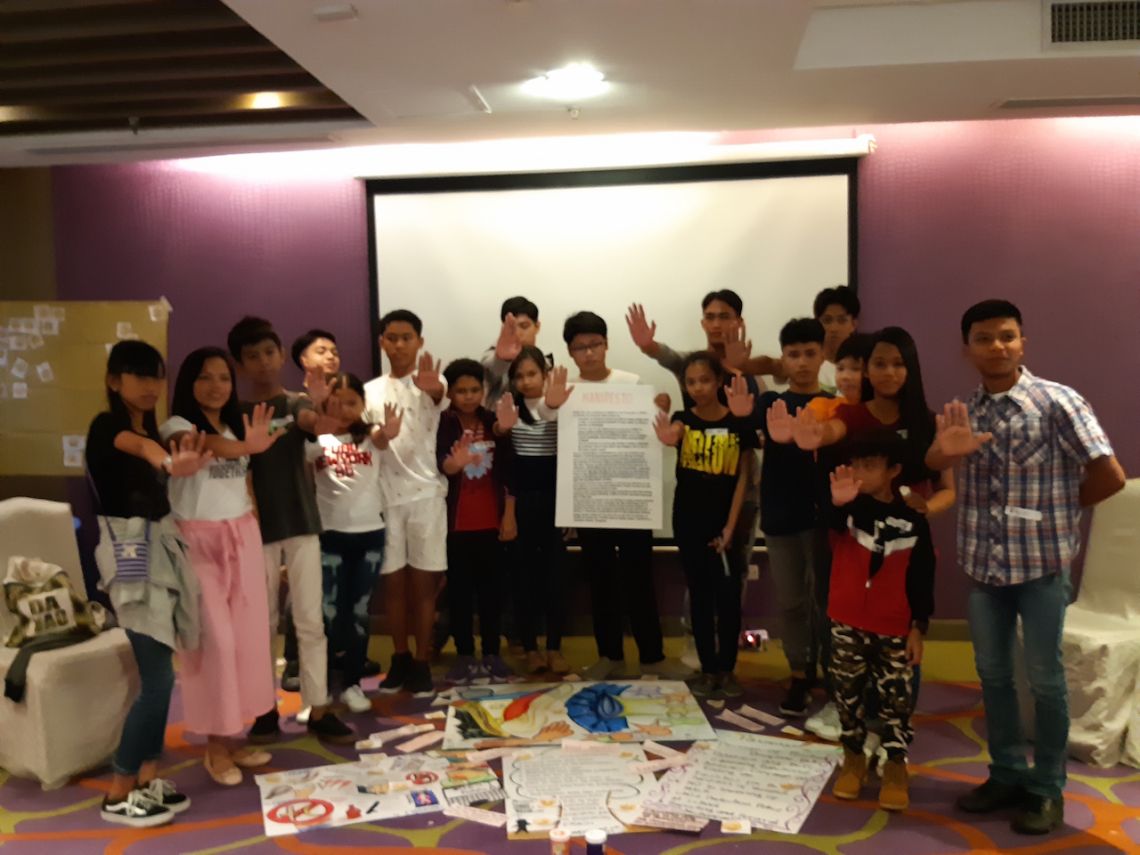 Children present their manifesto with the stop violence sign.jpg