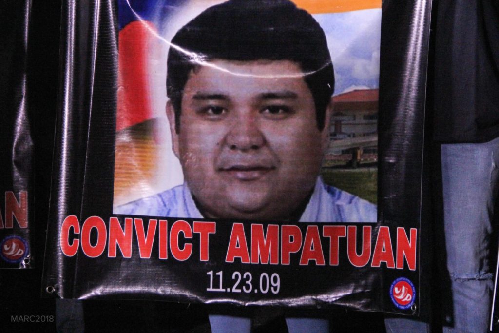 A tarpaulin bears the face of Sajid Ampatuan, one of the primary accused in the Maguindanao Massacre, with “CONVICT AMPATUAN” written across it in bold red letters.