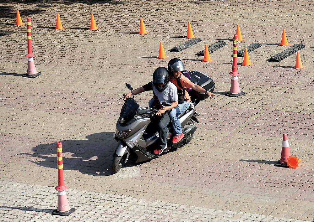 BIKE DRIVE LESSONS A rider avoids obstacles during practice runs at Angkas Training Center in San Andres Sports Complex in Manila. — RICHARD A. REYES