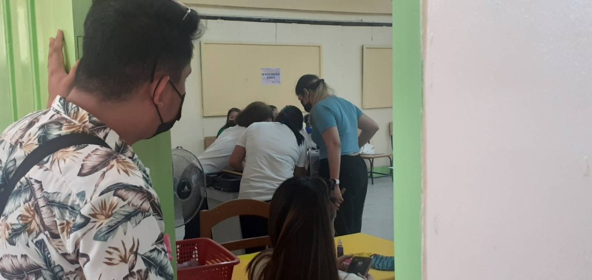 A poll watcher looks inside a classroom as a vote-counting machine in a clustered precinct atPio Del Pilar Elementary School in Sta. Mesa, Manila malfunctioned for the fifth time.