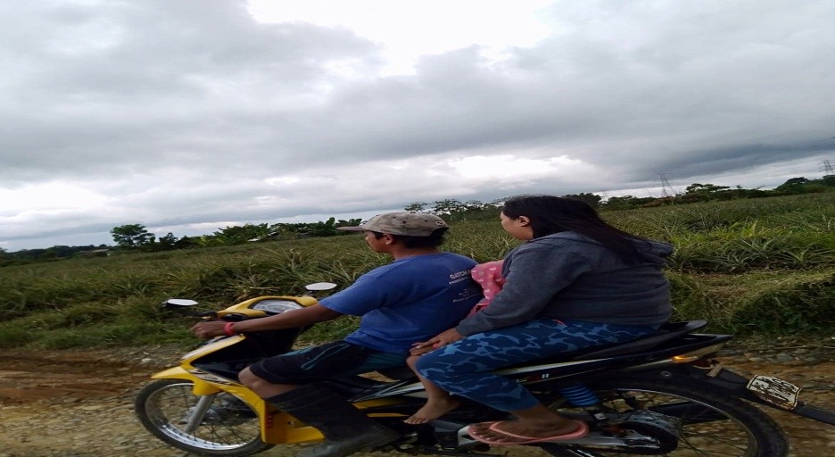 A woman and young girl riding on a habal-habal