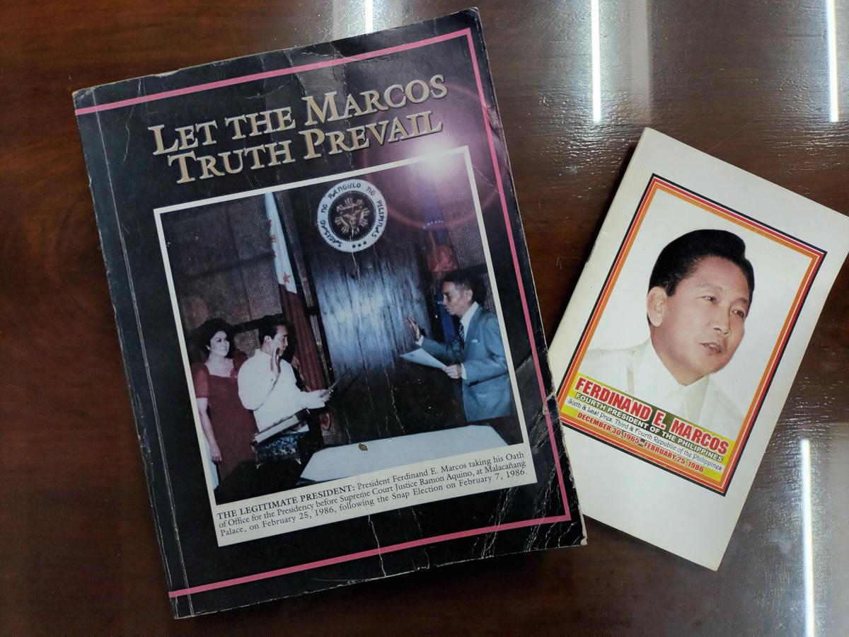 A pamphlet of Bullion Buyer Ltd. beside one of its key sources, a book distributed by Imelda Marcos