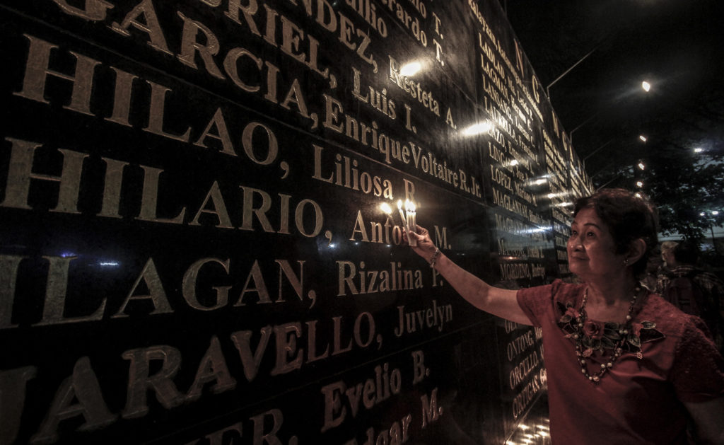 Alice Hilario Gualberto, sister of martial law activist Liliosa Hilao, lights candles at the Wall of Remembrance during the Annual Honoring of Martyrs and Honors of the People' Resistance to Dictatorship in the Bantayog ng mga Bayani on November 30, 2016.