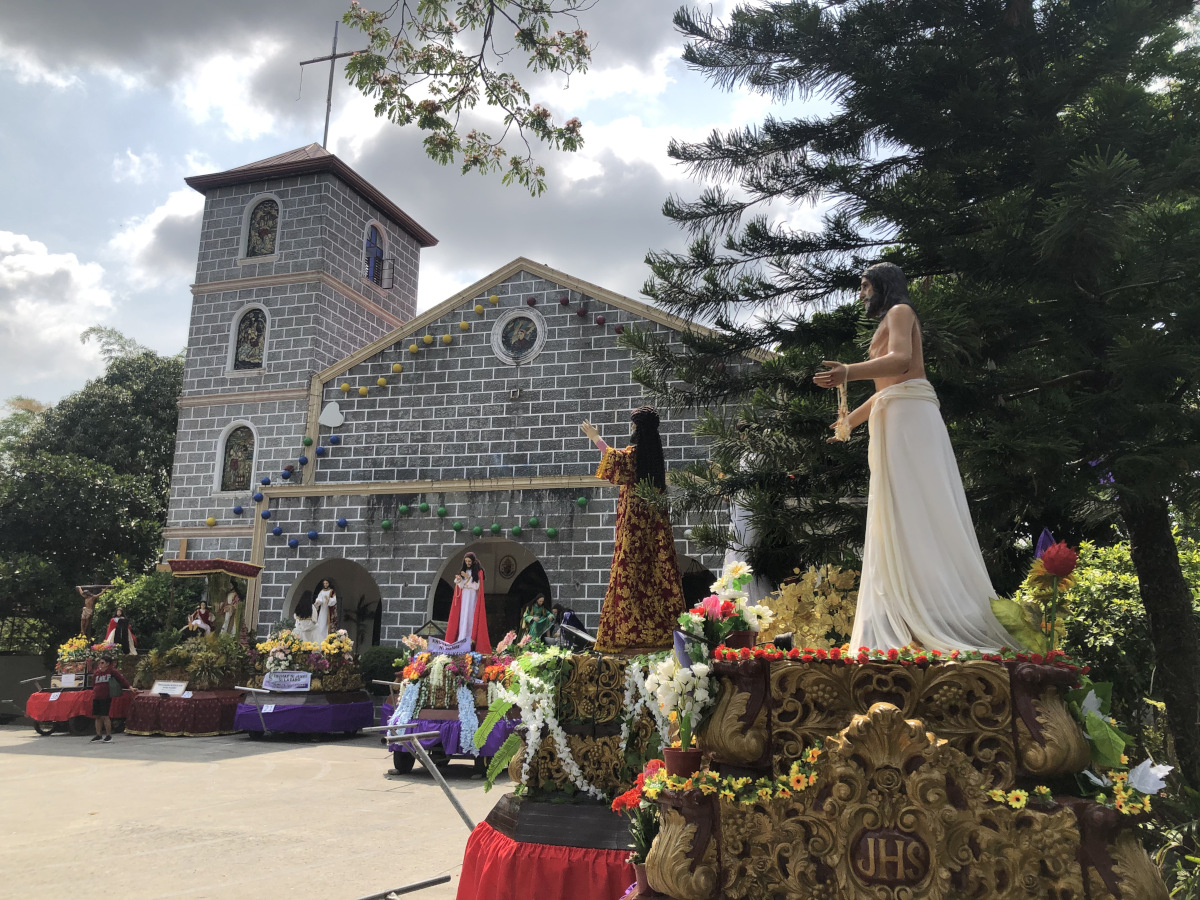 Floats with life-sized wooden statues are prepared for the Good Friday procession at the front yard of a church in Dona Remedios Trinidad, Bulacan
