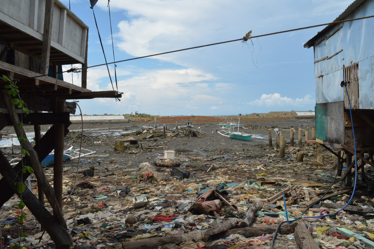 Waste and other storm debris in a coastal village in Talibon