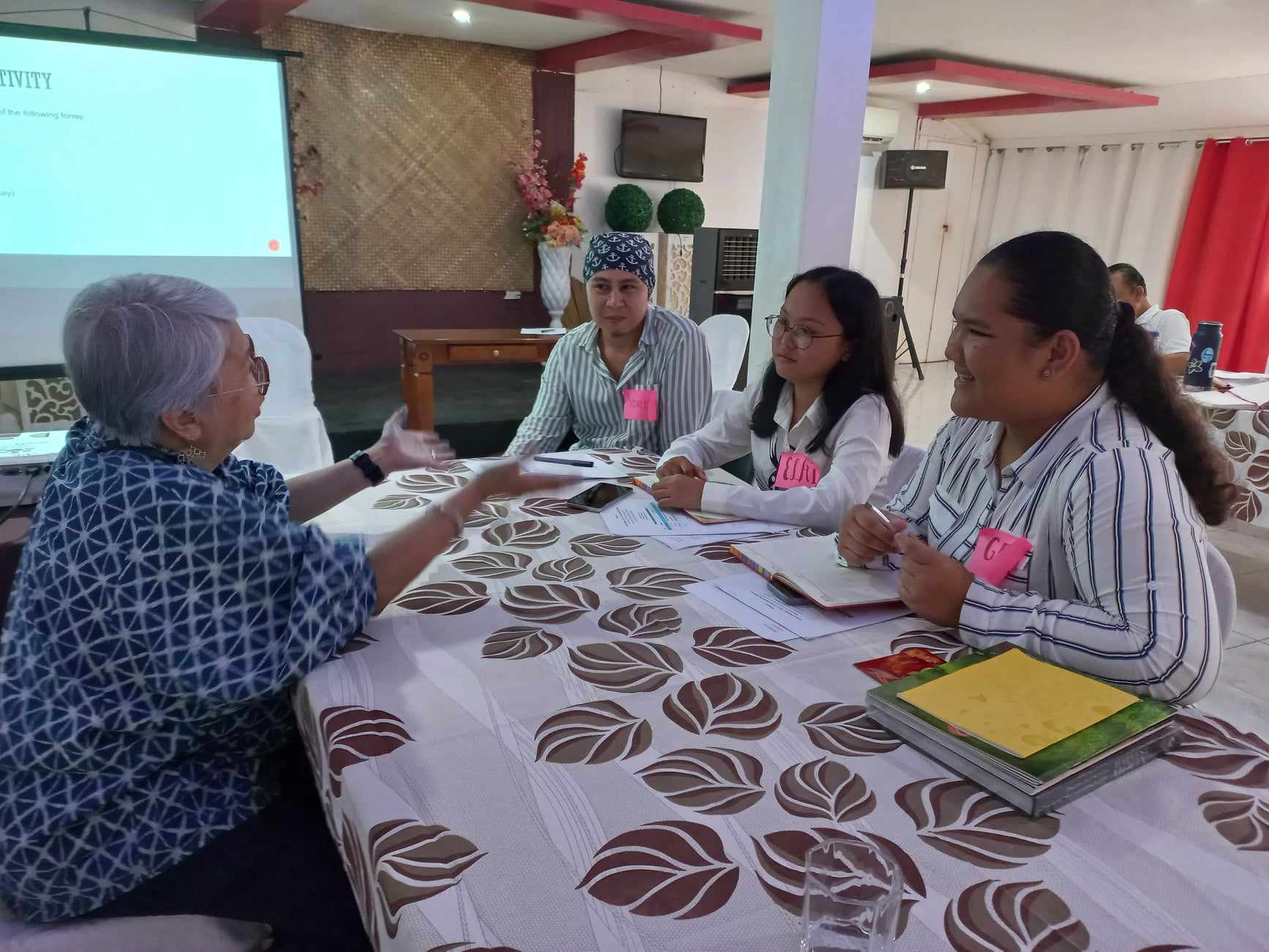Writer Marjorie Evasco (left) talks with student writers, participants of the Eco-Literature project in Bohol. (Cooper Resabal)