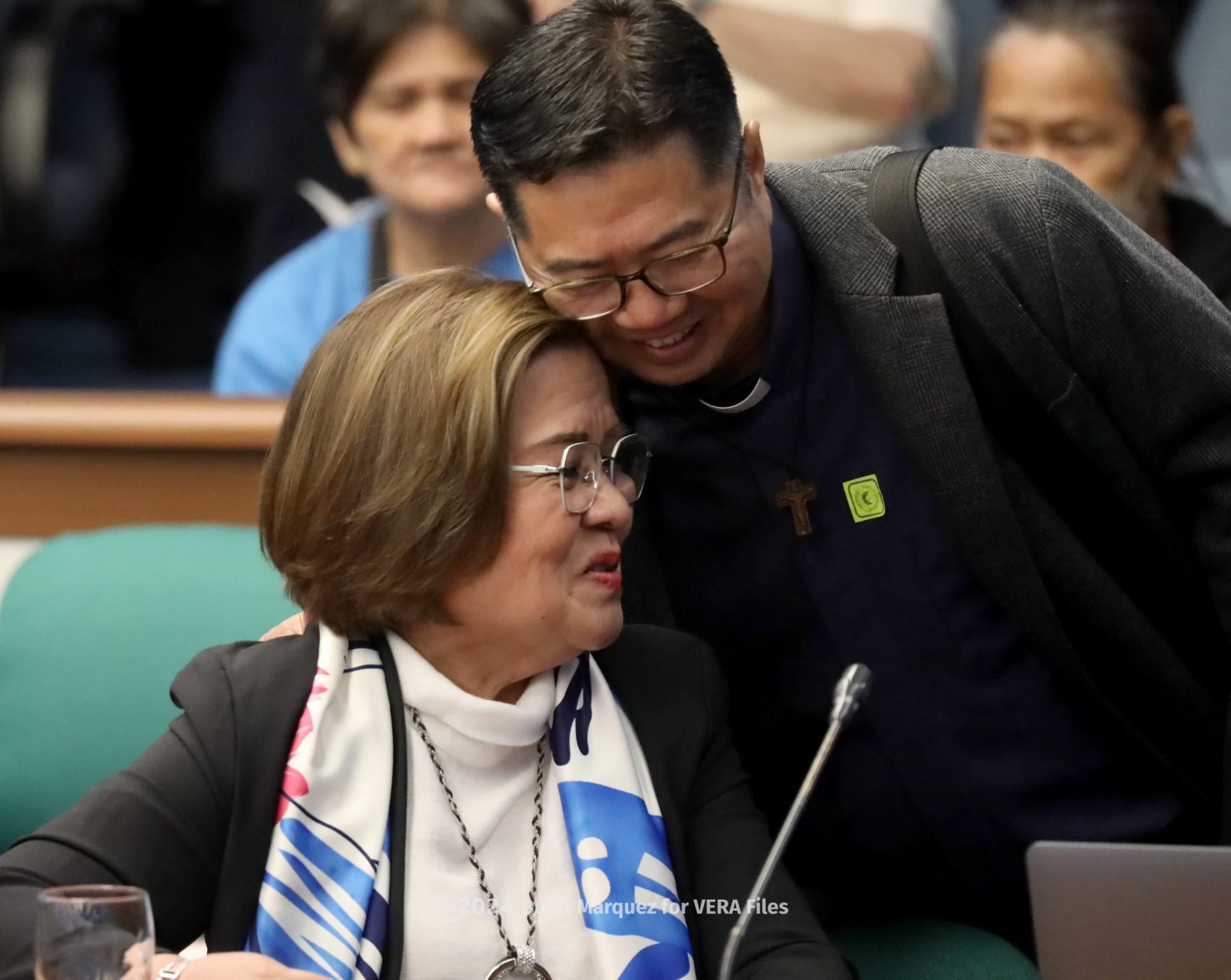 Fr. Flavie Villanueva of Program Paghilum greets former senator Leila de Lima before the start of the Senate hearing on the bloody war on drugs during the Duterte presidency. Photo by Bullit Marquez for VERA Files