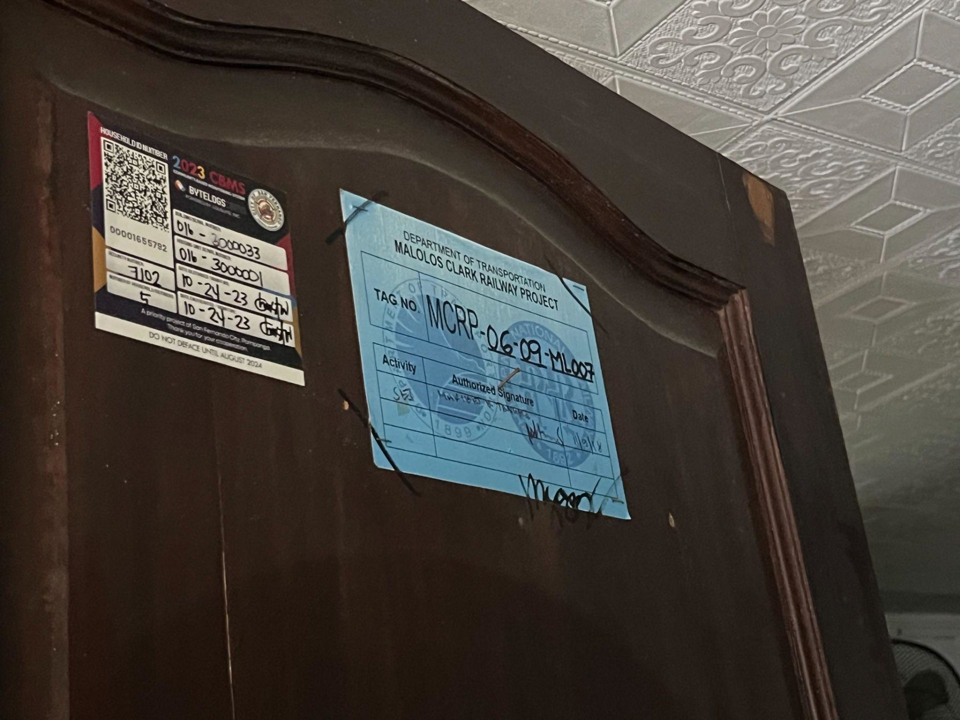 Photo shows door with census sticker for the Malolos-Clark Railway Project