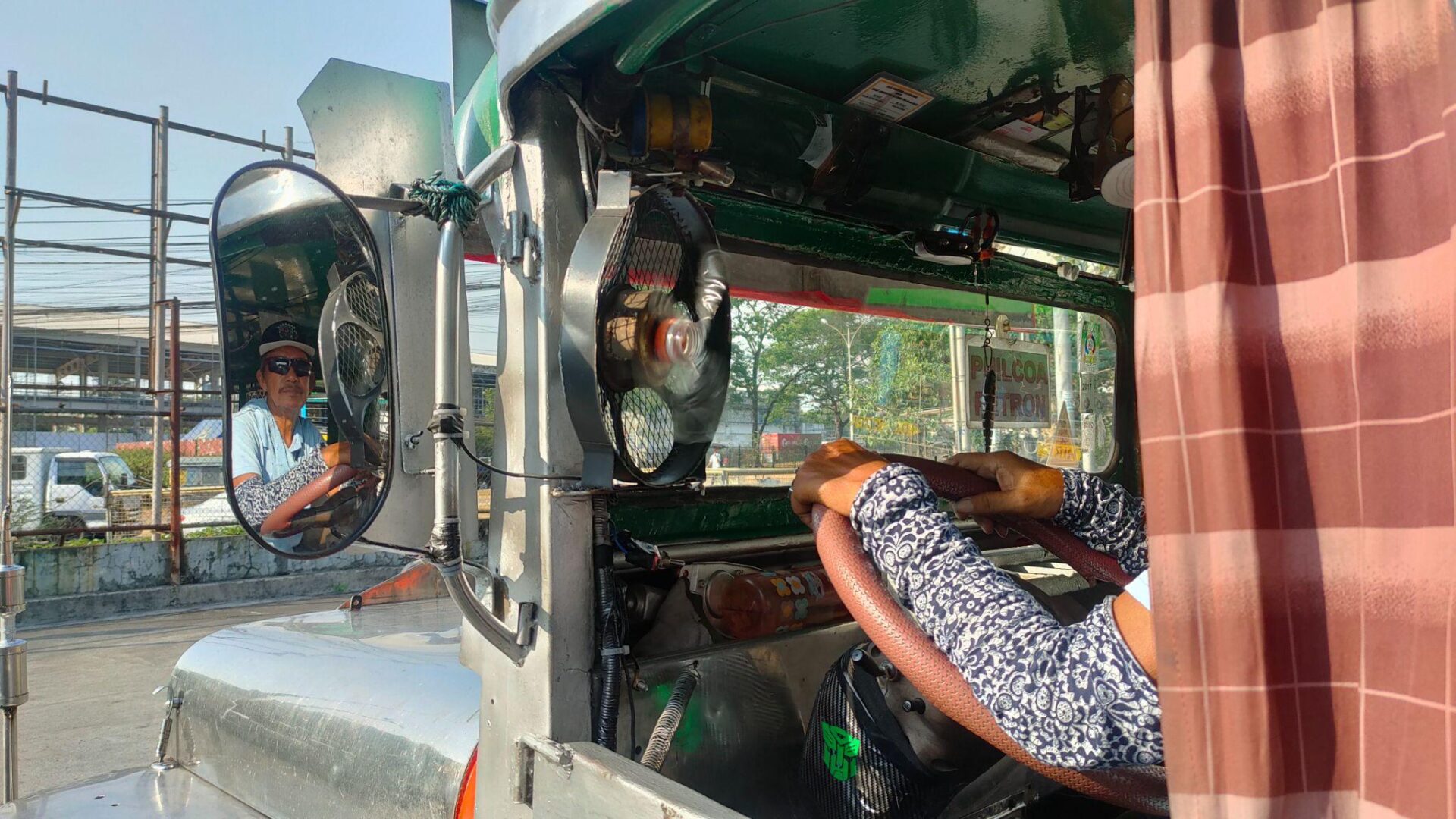 Amando Tenegra waits behind the wheel of his jeepney along the UP-PhilCoA route in Quezon City.