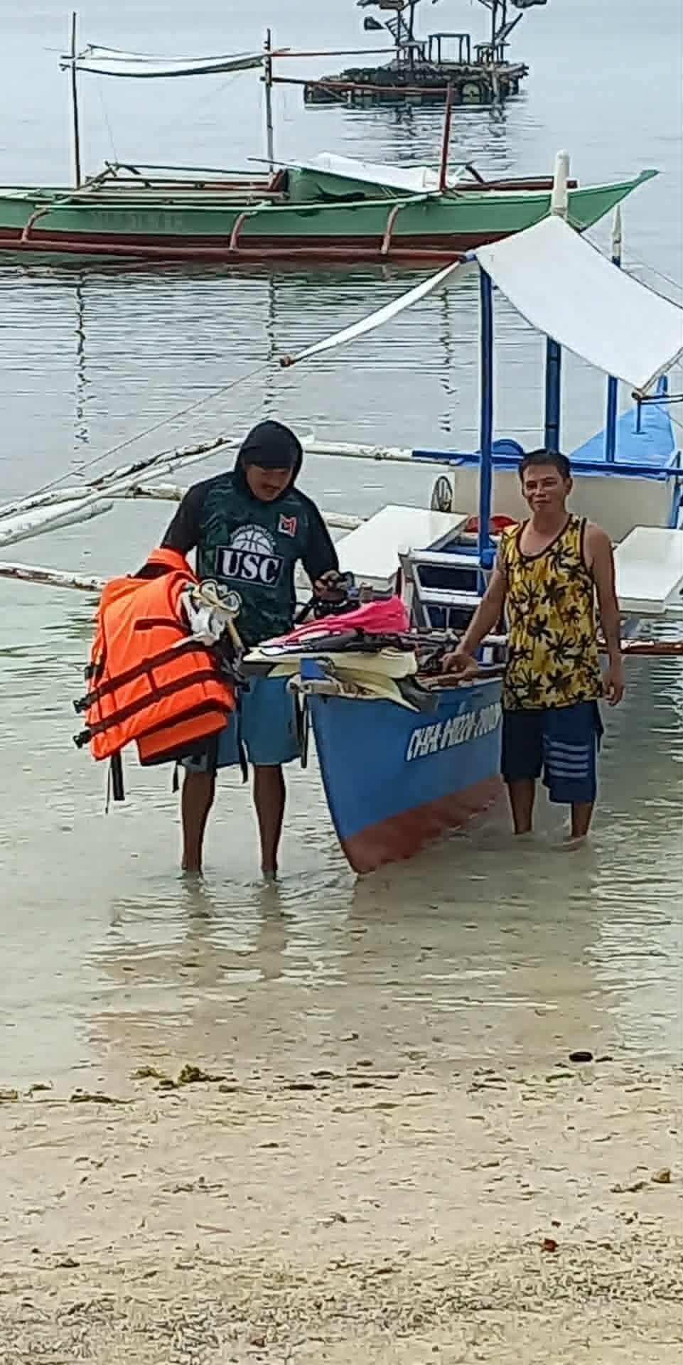 Fisherfolk boat operator and guide at Bingag shore.