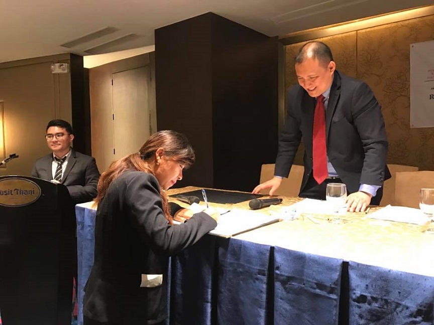 Lawyer from Myanmar signing her organization's approval of the statement on SB92. Looking on is AFEC-SEA Chair Gilber Andres. Photo from Andres' Facebook..jpg