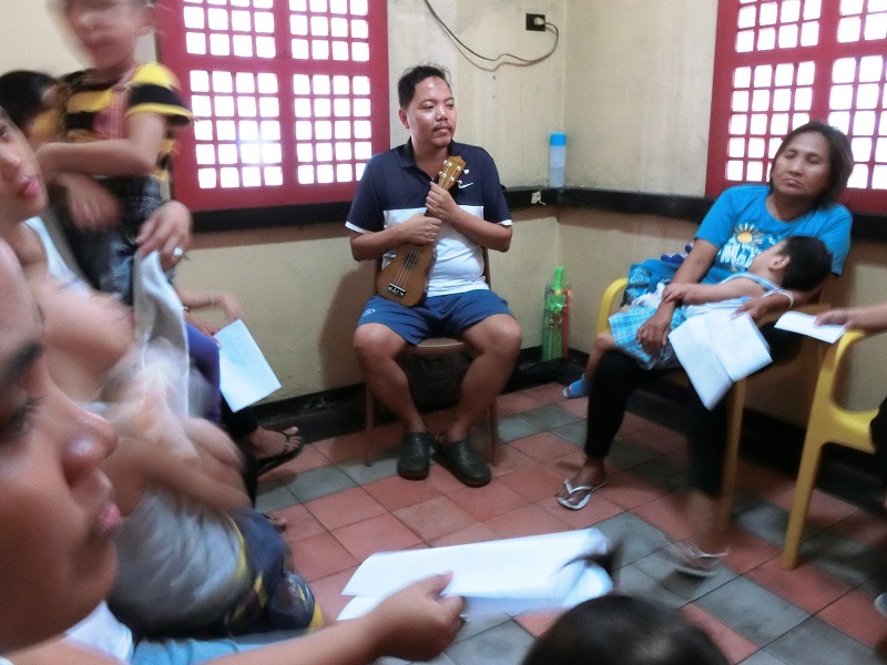 Dondi Ong, center, facilitating a music therapy session at Gota de Leche building.jpg
