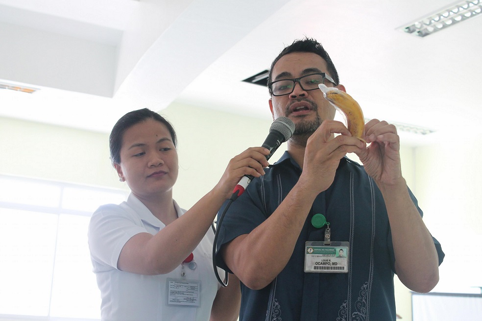 Dr. Ocampo demonstrates the proper use of condom.jpg
